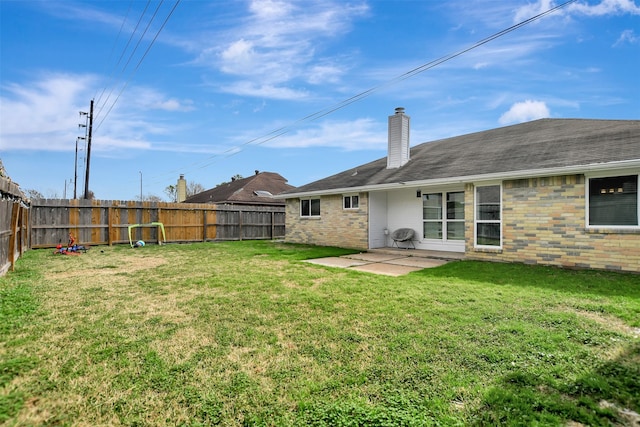 back of property with a lawn and a patio