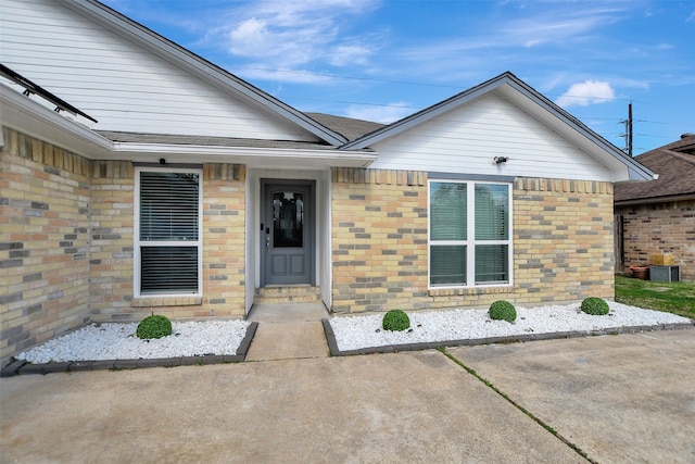 view of exterior entry featuring a patio area