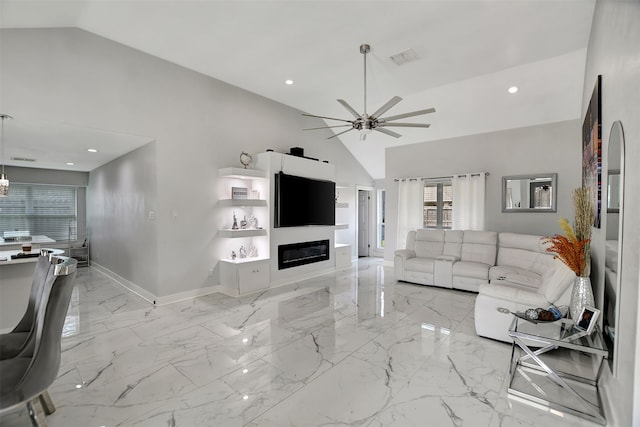 living room with ceiling fan and high vaulted ceiling