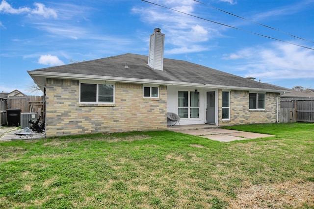 back of property with a patio, central AC unit, and a lawn