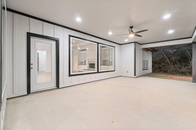 interior space with crown molding and ceiling fan