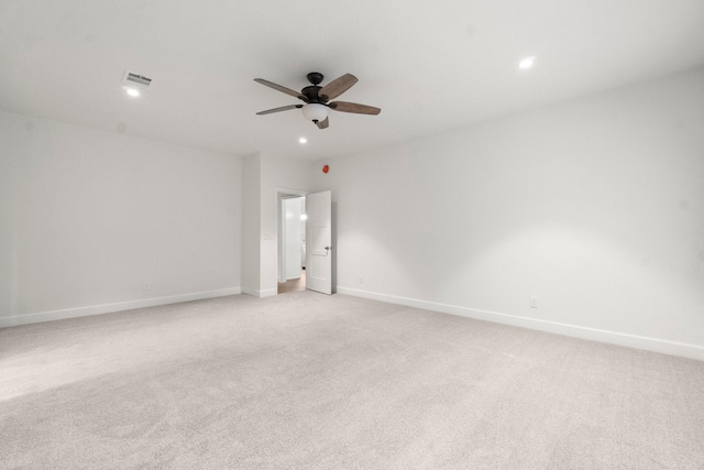 spare room featuring light carpet and ceiling fan