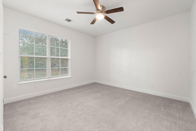 carpeted spare room with ceiling fan