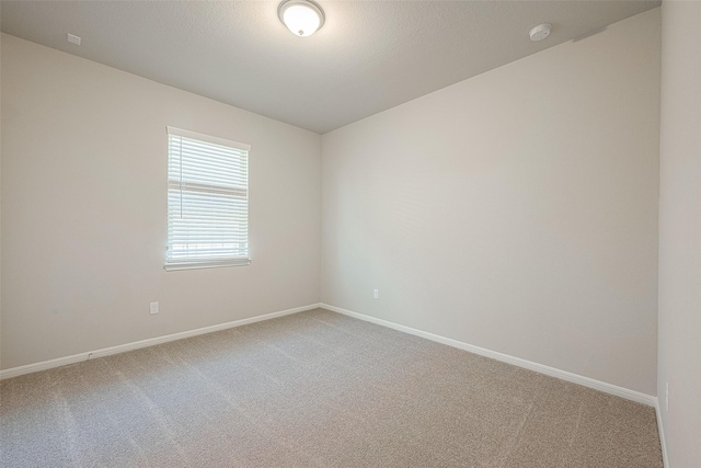 carpeted spare room featuring a textured ceiling