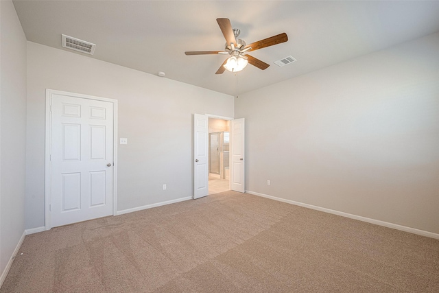 unfurnished bedroom with ceiling fan, carpet floors, and ensuite bath