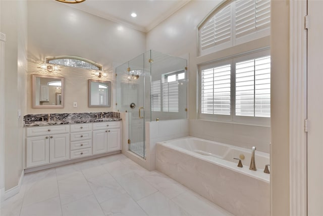 bathroom featuring ornamental molding, separate shower and tub, and vanity