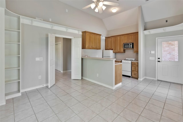 kitchen featuring light tile patterned floors, white appliances, ceiling fan, vaulted ceiling, and kitchen peninsula