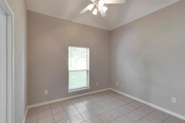 tiled spare room featuring ceiling fan