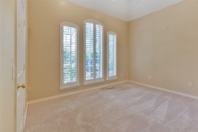 carpeted empty room featuring plenty of natural light