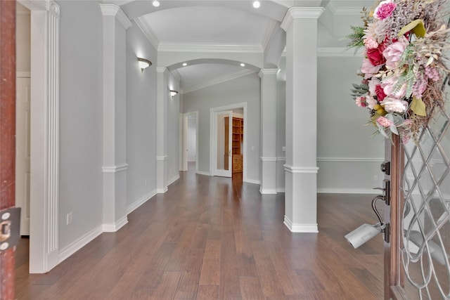 foyer with decorative columns, crown molding, and dark hardwood / wood-style floors