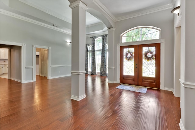 entryway with wood-type flooring, ornamental molding, french doors, and ornate columns