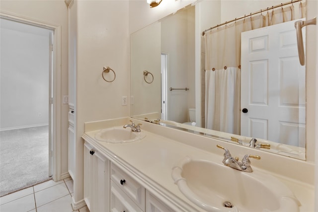 bathroom featuring vanity, tile patterned floors, and toilet