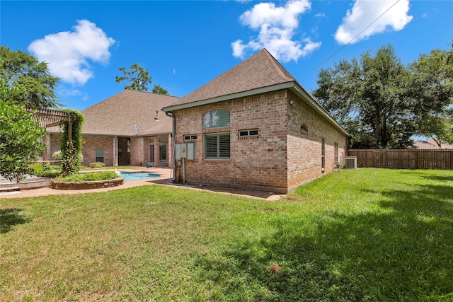 back of house with a fenced in pool, a yard, central AC, and a pergola