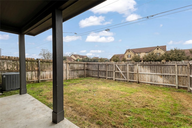 view of yard with central AC and a patio area