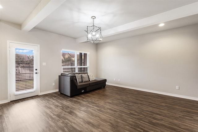 unfurnished room with beamed ceiling, dark hardwood / wood-style flooring, and an inviting chandelier