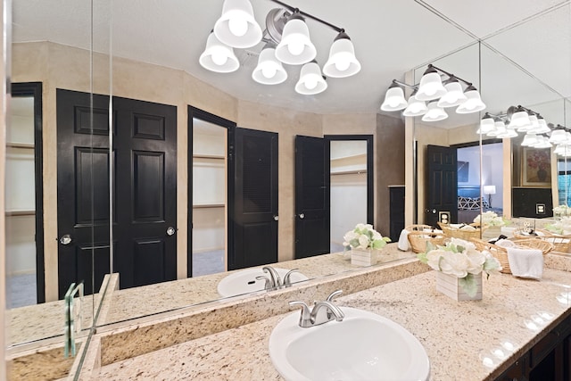 bathroom featuring vanity and a chandelier