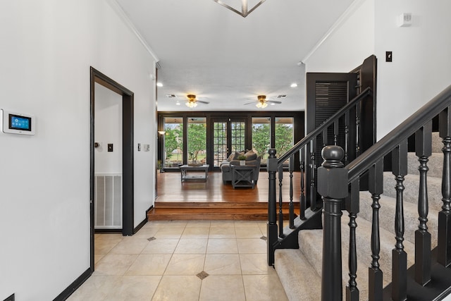 entryway featuring light tile patterned flooring, ceiling fan, and ornamental molding