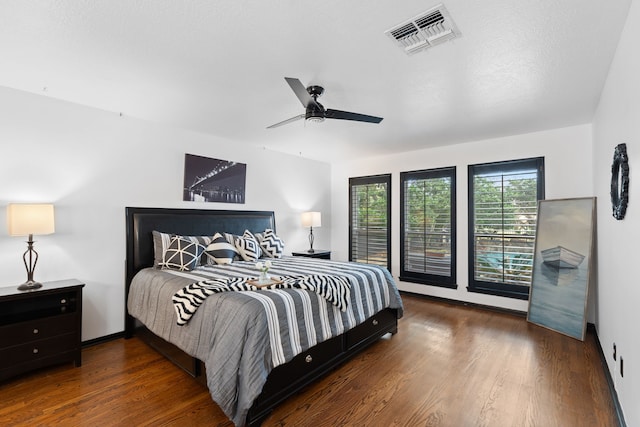 bedroom featuring dark hardwood / wood-style flooring and ceiling fan