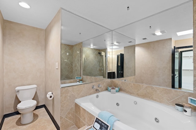 bathroom featuring tile patterned floors, toilet, and separate shower and tub