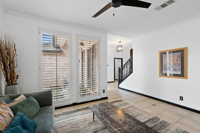 living room with ornamental molding, light tile patterned flooring, and ceiling fan