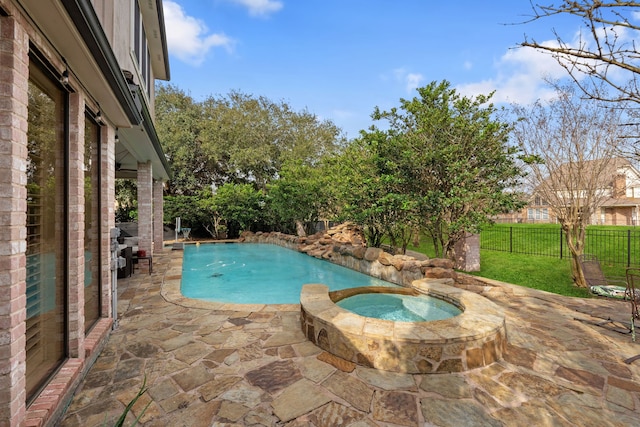 view of pool with an in ground hot tub and a patio