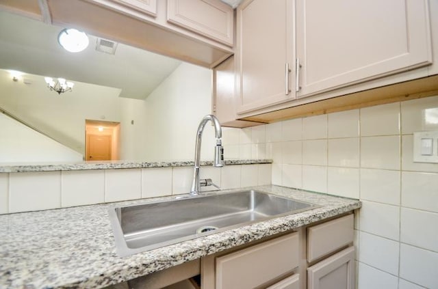 kitchen with light stone countertops and sink