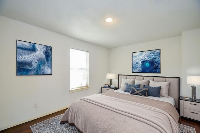 bedroom with dark hardwood / wood-style flooring