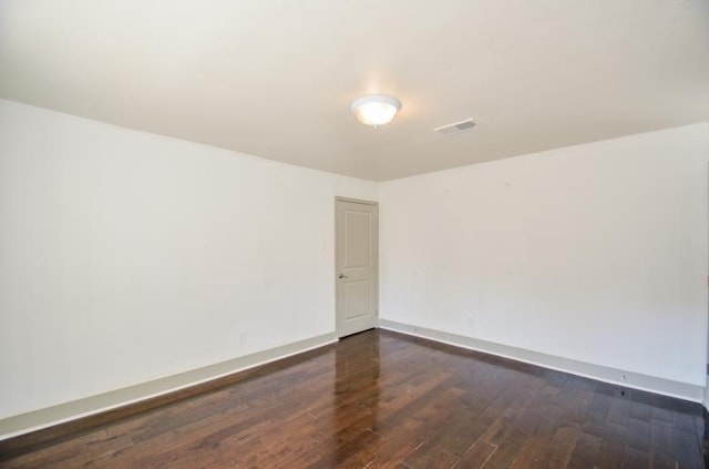 unfurnished room with dark hardwood / wood-style floors