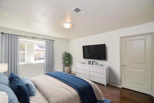 bedroom with dark hardwood / wood-style flooring