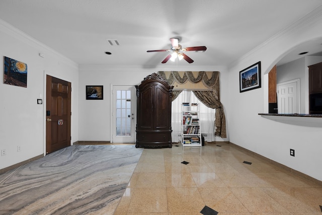 foyer with ornamental molding and ceiling fan