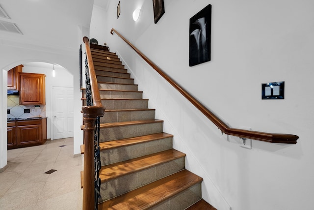 staircase featuring crown molding