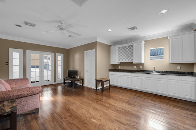 interior space with french doors, sink, white cabinetry, light hardwood / wood-style flooring, and ceiling fan