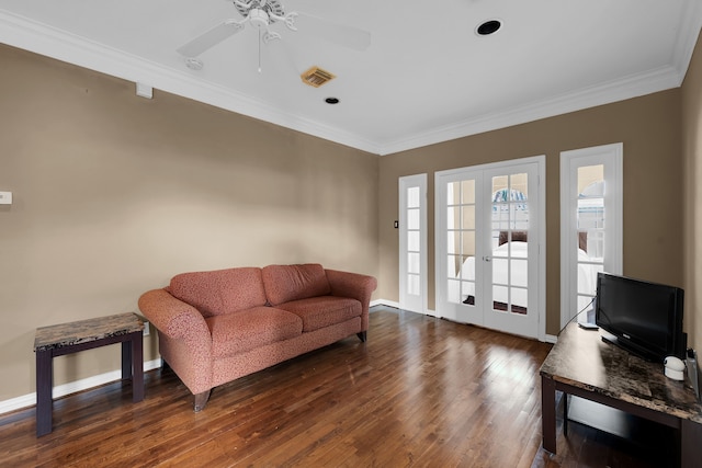 living area with ornamental molding, dark wood-type flooring, ceiling fan, and french doors