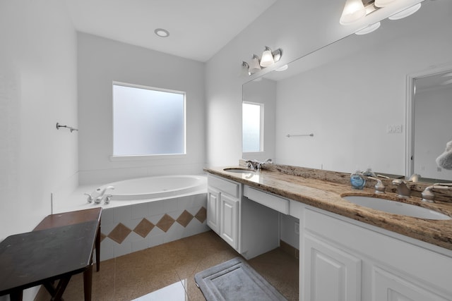 bathroom featuring vanity and tiled bath