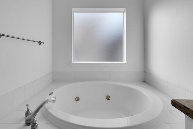 bathroom featuring tiled bath