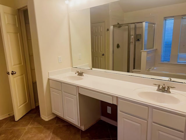 bathroom with tile patterned flooring, vanity, and separate shower and tub