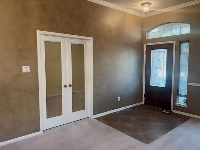 foyer with crown molding, french doors, and dark tile patterned floors