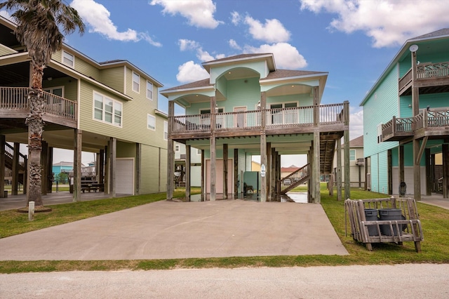 exterior space with a carport, stairway, and concrete driveway