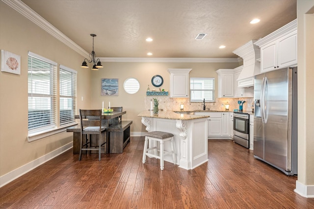 kitchen featuring visible vents, appliances with stainless steel finishes, light stone counters, and white cabinets