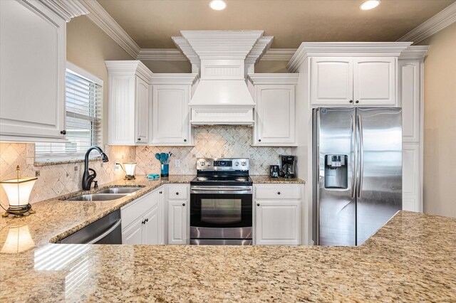 kitchen with white cabinetry, ornamental molding, appliances with stainless steel finishes, and sink