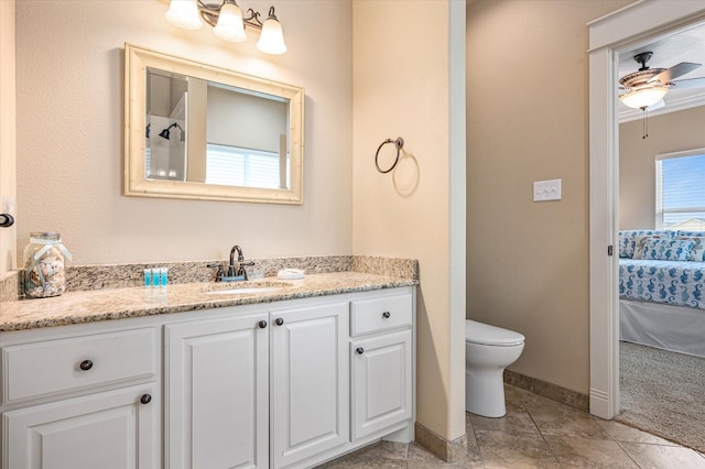 bathroom featuring vanity, ceiling fan, and toilet