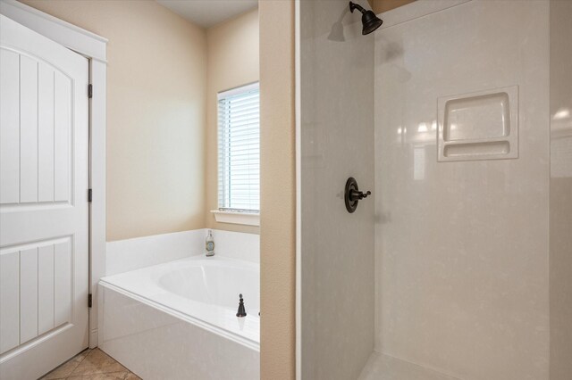 bathroom featuring tile patterned floors and independent shower and bath