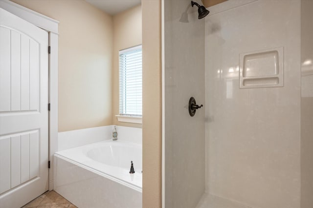 bathroom with a garden tub, a shower stall, and tile patterned floors