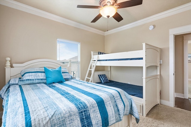 carpeted bedroom with ornamental molding, a ceiling fan, and baseboards