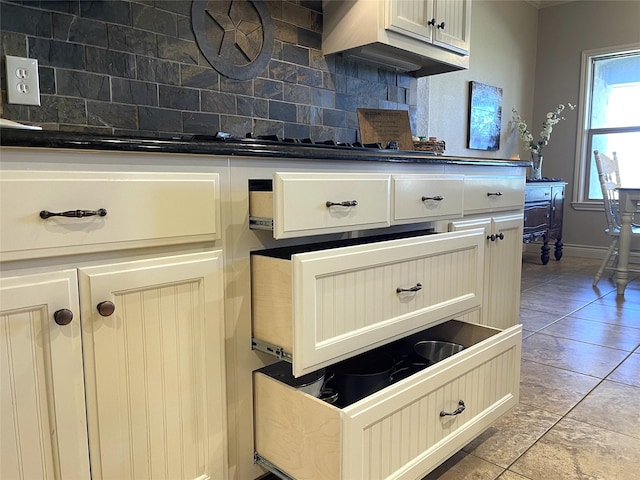 kitchen featuring light tile patterned floors and backsplash