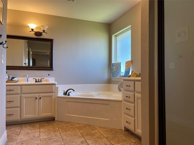 bathroom with a washtub and vanity