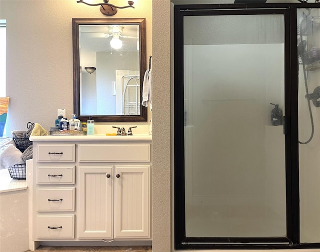 bathroom with a shower with door and vanity