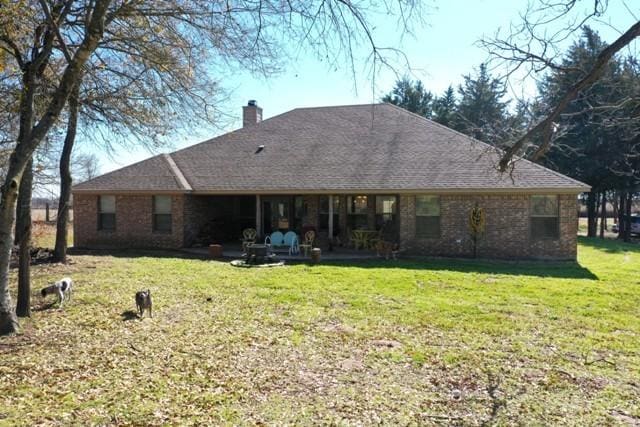 rear view of house with a lawn