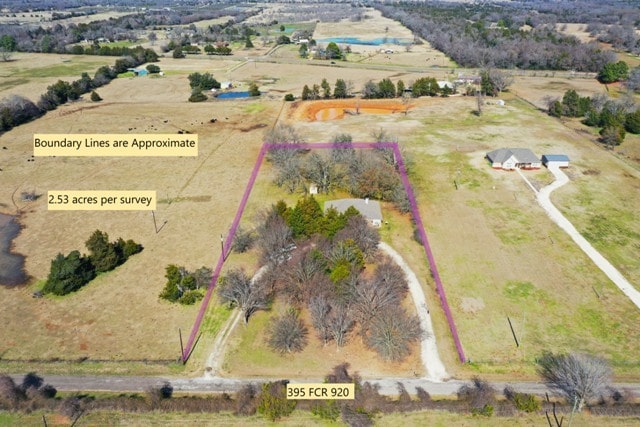 birds eye view of property with a rural view