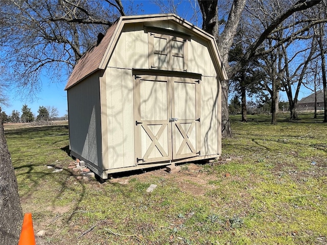 view of outbuilding featuring a lawn